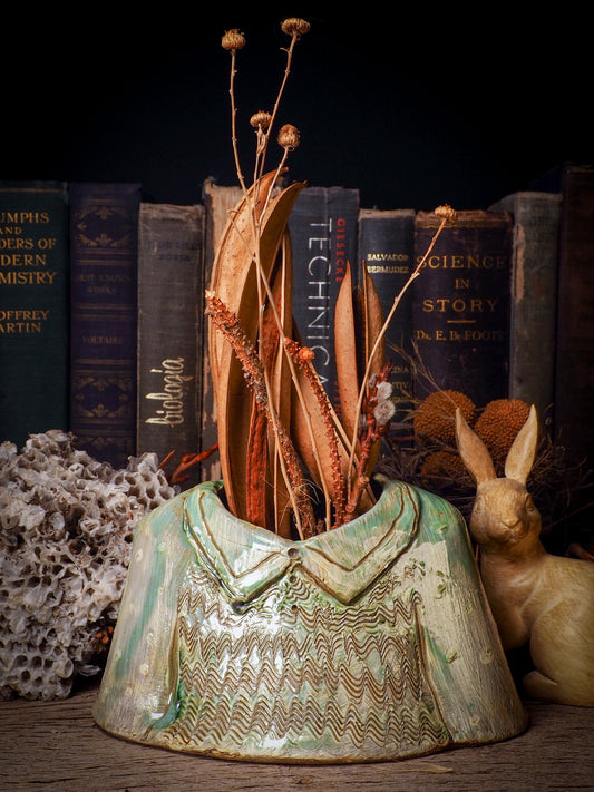 Using hand pinching techniques in of a kind fire glazed ceramics, Idania Salcido, the artist behind Danita Art, sculpted glazed ceramic clay vase containers and flower pots in the shape of vintage blouses. Beautiful accents for your dinner table, showcase or anywhere you want to remind you of family and love.